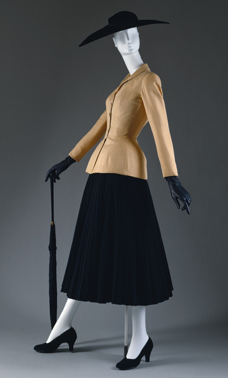 The “Bar” suit featured here is one of Dior’s most iconic designs. Featured in his first collection, it epitomizes all the elements of the “New Look”: the ensemble’s corset-like bodice is characterized by rigid corsetry, a wasp-waist and padded hips while the accompanying skirt is full and wide. "Bar" suit and jacket, spring/summer 1947 Christian Dior, Silk shantung; Skirt, executed in 1969 from a 1947 design Reproduction of a skirt designed by Christian Dior; reproduction of a skirt, wool. Both in the collection of the Metropolitan Museum of Art. 